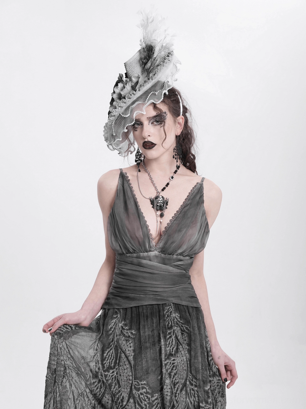 Black and white floral fascinator hat capturing light with feathers for dramatic gothic fashion statement
