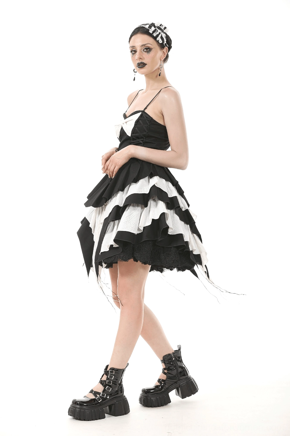 Front three-quarter view black and white gothic ruffled dress with spaghetti straps and bow