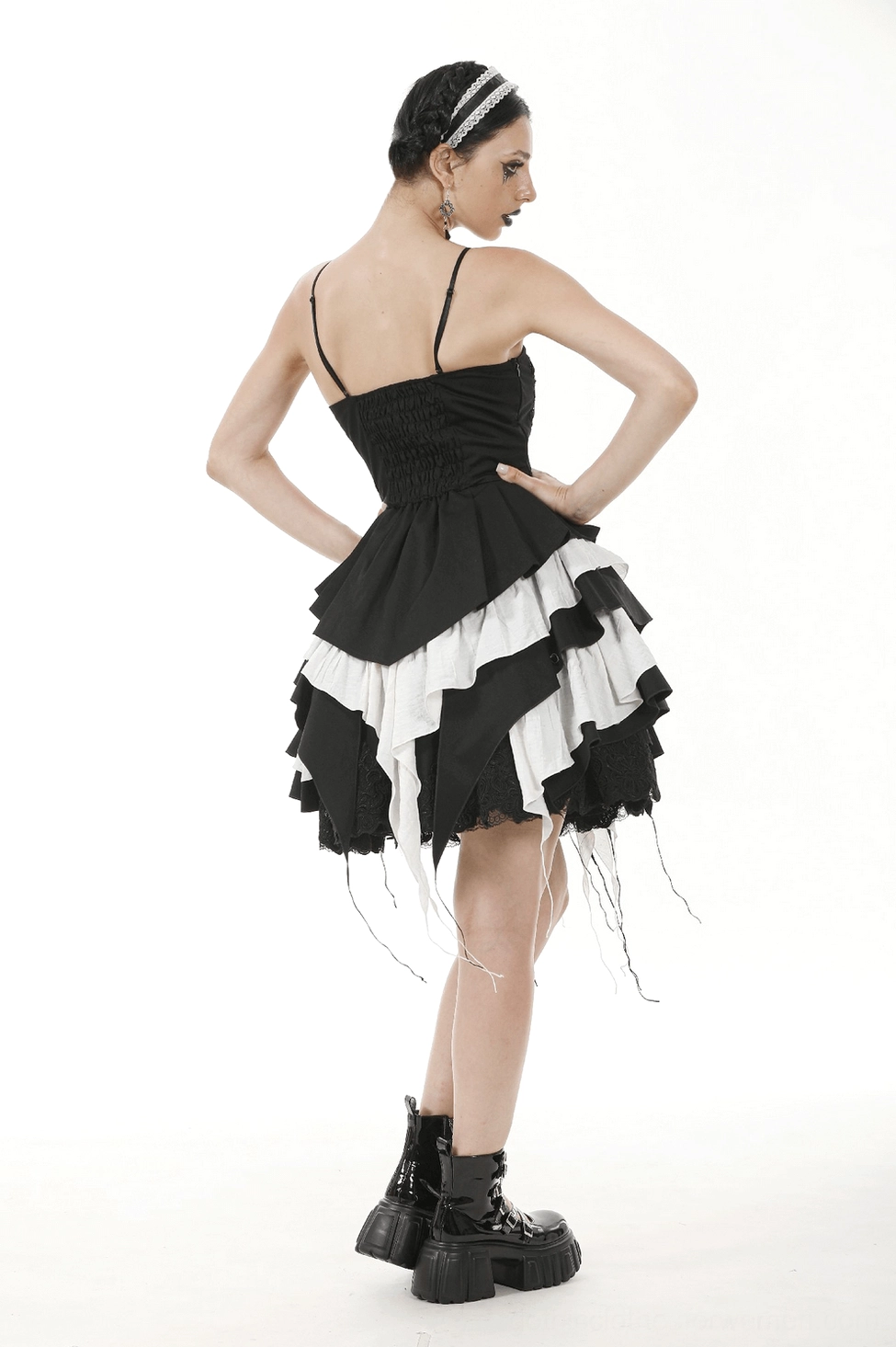 Black and white ruffled gothic dress on model showing overall silhouette and alternative fashion aesthetic