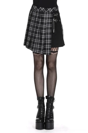 Black and white tartan asymmetrical gothic mini skirt with safety pin hardware, front three-quarter view on model