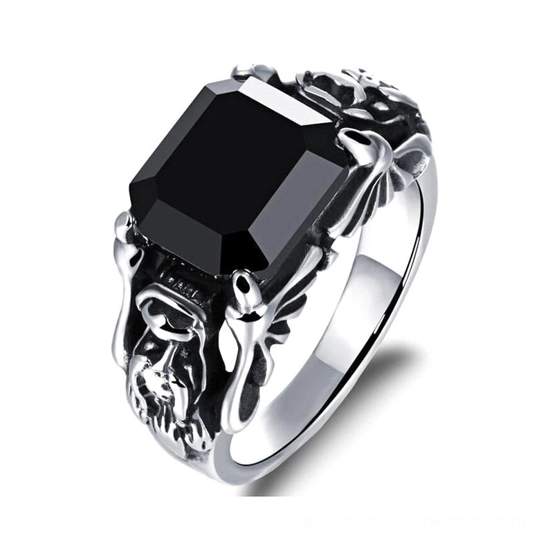 Black zircon gothic ring with winged skull motifs and square black gemstone, three-quarter front view showcasing carved stainless steel frame