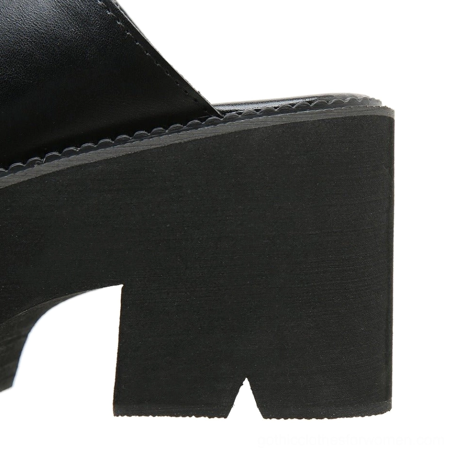 Heel section close-up showing matte black block heel with stitched edge detail craftsmanship