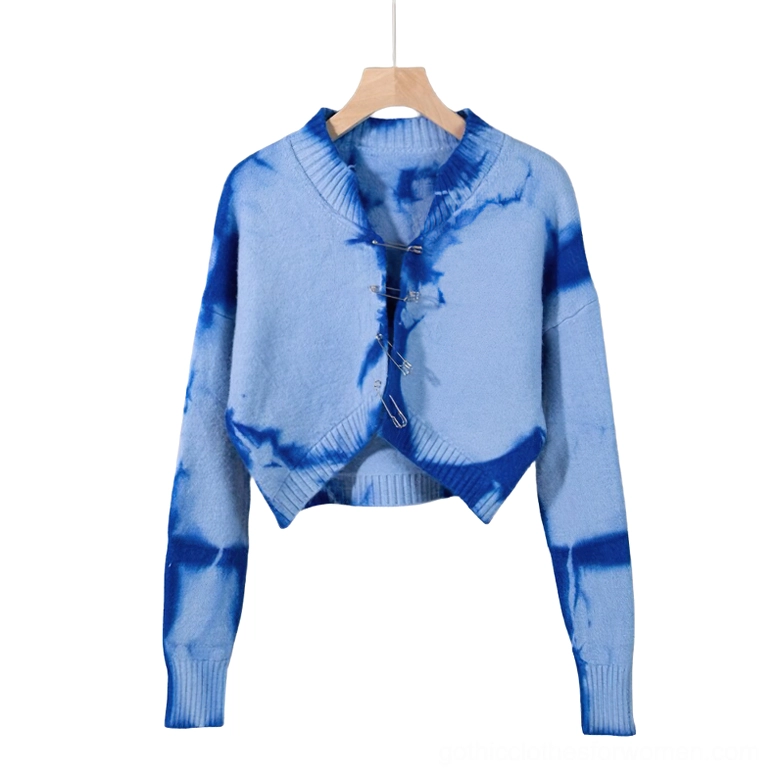 Blue tie-dye gothic cropped cardigan with silver safety pin closures, flat lay presentation