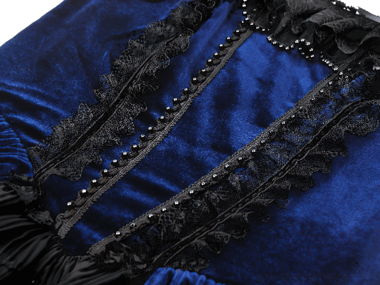 Macro detail of Gothic Lolita dress bodice featuring lace trim, tiny beaded accents, and smooth velvet surface finish