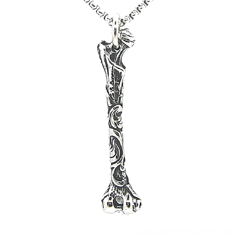 Carved bone stainless steel gothic pendant necklace overhead view with intricate floral engravings