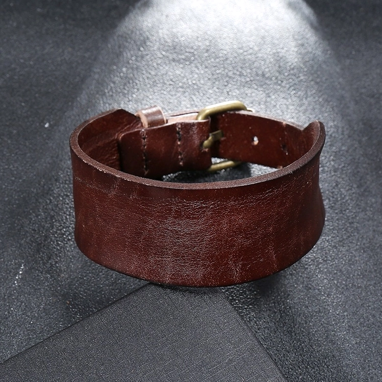 Brown wide leather gothic bracelet close-up of leather texture and vintage buckle