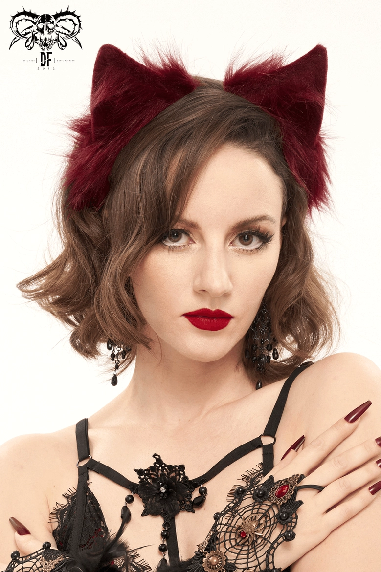 Side profile of burgundy cat ear headband paired with spider web lace gloves and gothic accessories