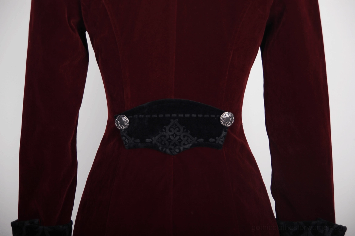 Burgundy velvet coat waist detail - embossed black trim and engraved metal buttons