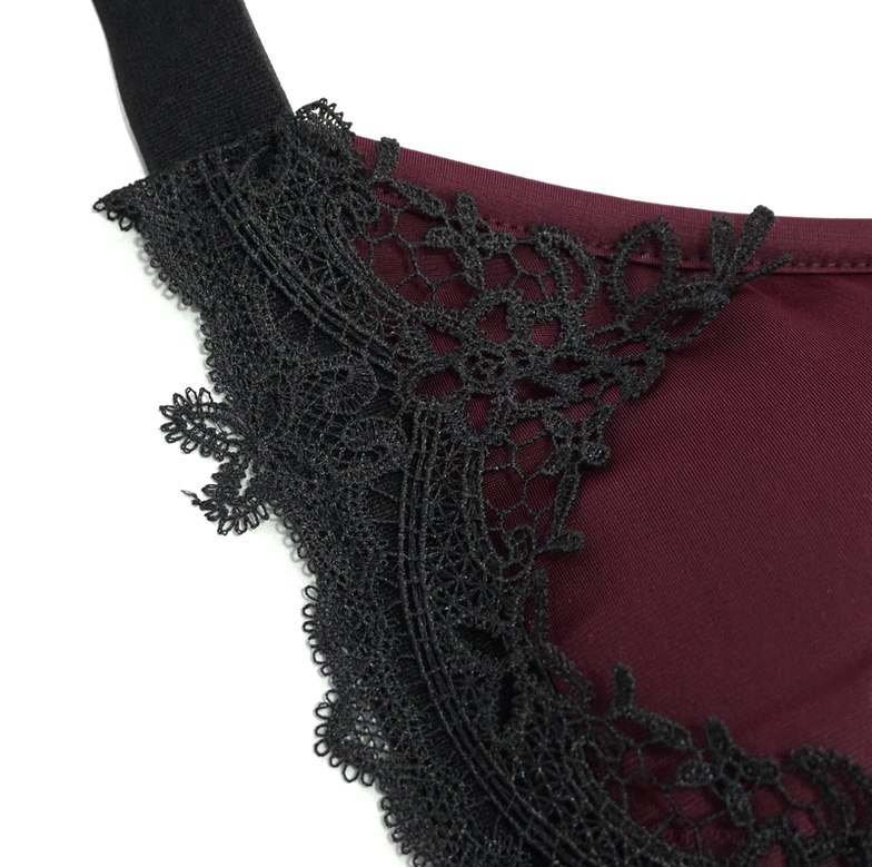 Detailed close-up of burgundy gothic bikini bottom lace appliqué showing floral black lace on burgundy base fabric