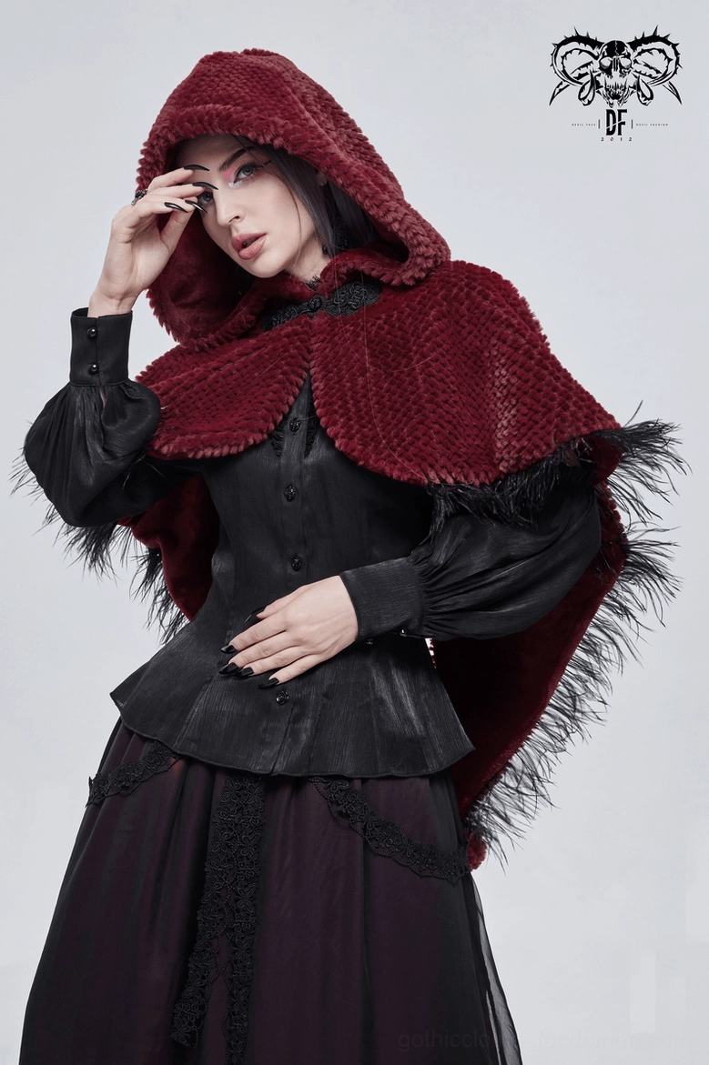 Female model three-quarter right view in wine red gothic cape adjusting hood with vintage goth ensemble