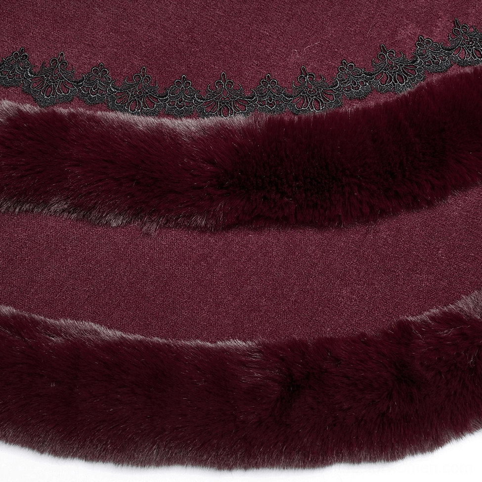Close-up of burgundy hooded cloak hem trim featuring ornate black lace and layered faux fur details
