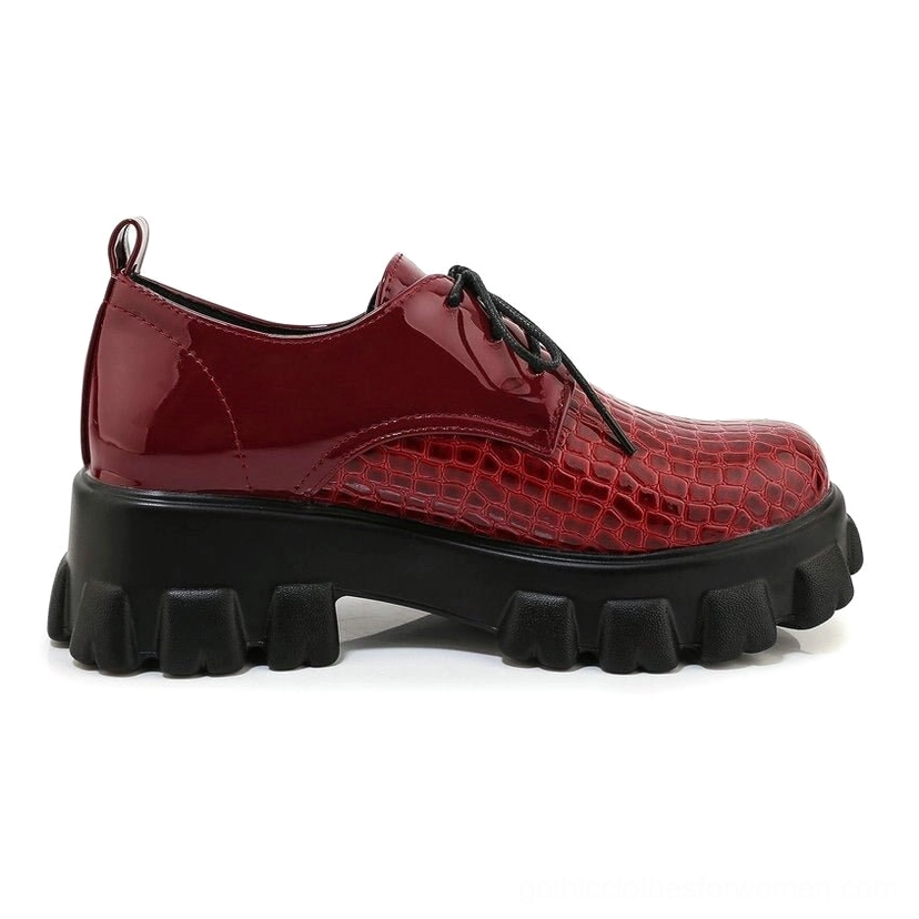 Burgundy wine-dark snake-grain platform pump side profile view, showing lug sole and architectural heel design