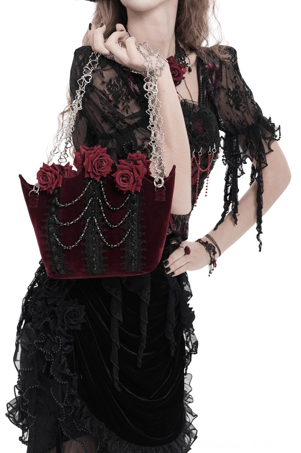 Burgundy gothic rose handbag three-quarter front view on model in dark lace dress, featuring silver chain shoulder straps and sculpted roses