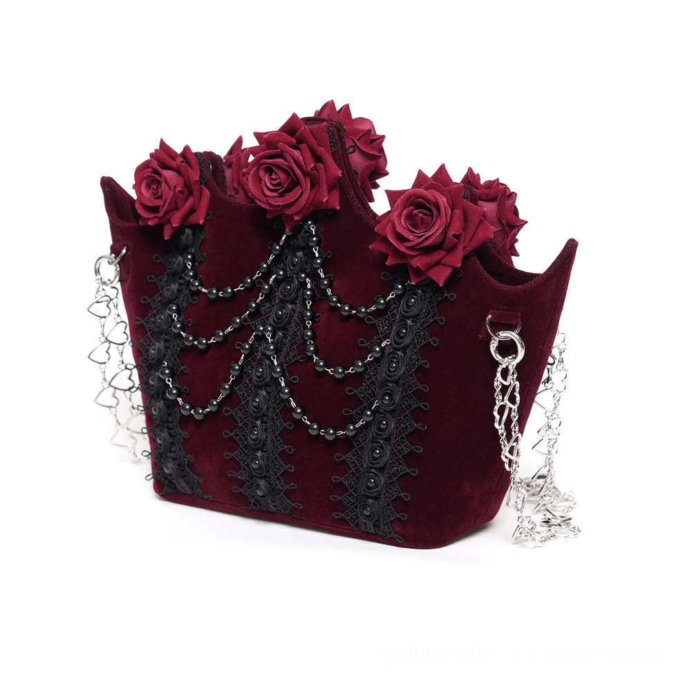Burgundy gothic rose handbag front perspective showing four red roses, metal chain shoulder straps, and layered lace embellishments