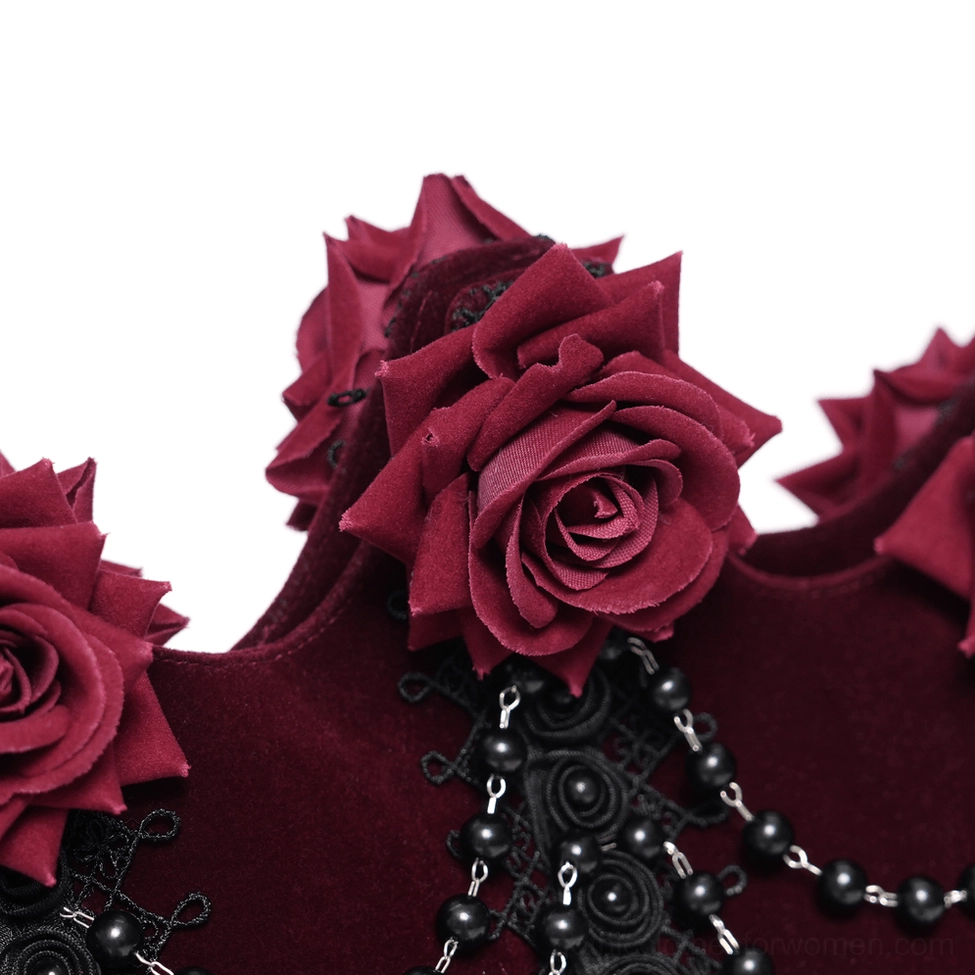Close-up macro detail of burgundy gothic handbag showing flocked red roses, beaded black chains, and embroidered lace patterns