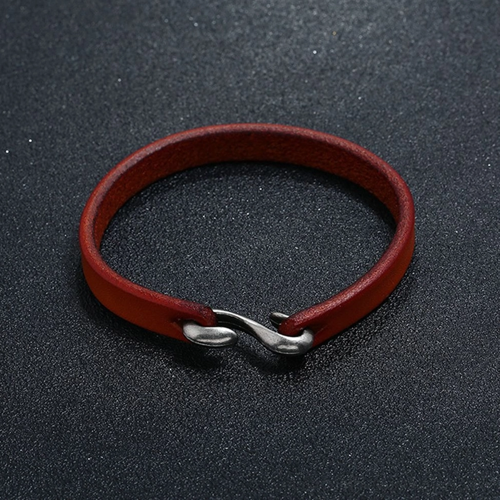Dark reddish-brown genuine leather narrow cuff bangle with vintage silver hook clasp - gothic aesthetic flatlay