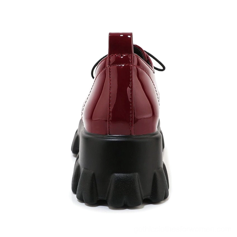 Platform pump rear view showing deep burgundy snake-pattern leather and substantial lug sole for grip and stability