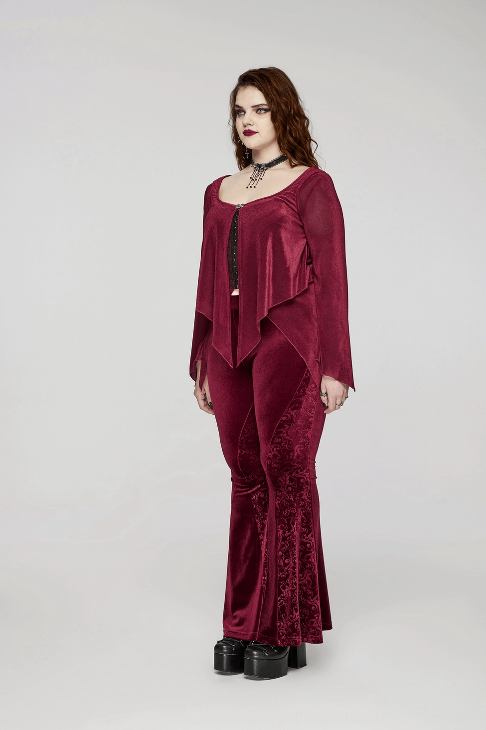 Burgundy velvet gothic flared pants alternative fashion styling with embossed details and dramatic hem