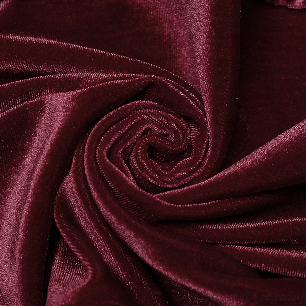 Close-up texture detail of plush burgundy velvet fabric showing rich color and soft drape
