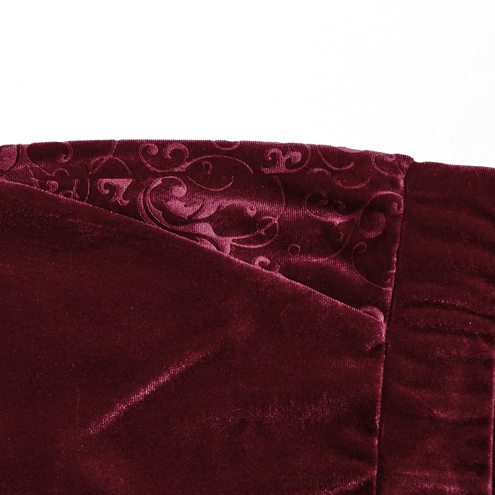Close-up detail of embossed side panel scroll design on burgundy velvet gothic trousers