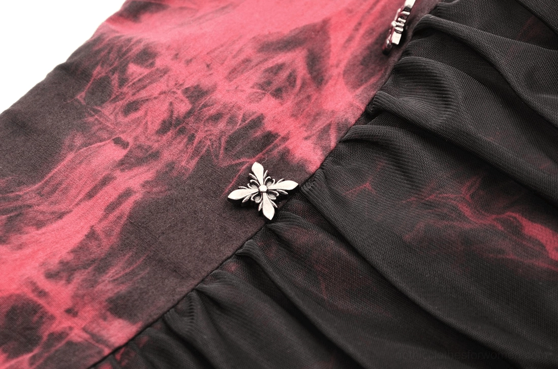 Close-up of butterfly-shaped metal buckle fastener on red and black gothic corset, showing tie-dye pattern detail