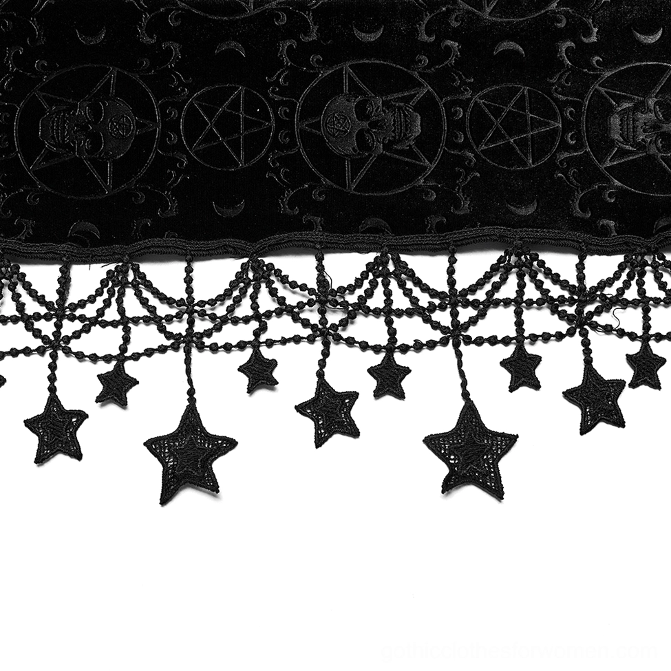 Flat lay close-up of skull and pentagram embroidery with star tassels on gothic cape fabric