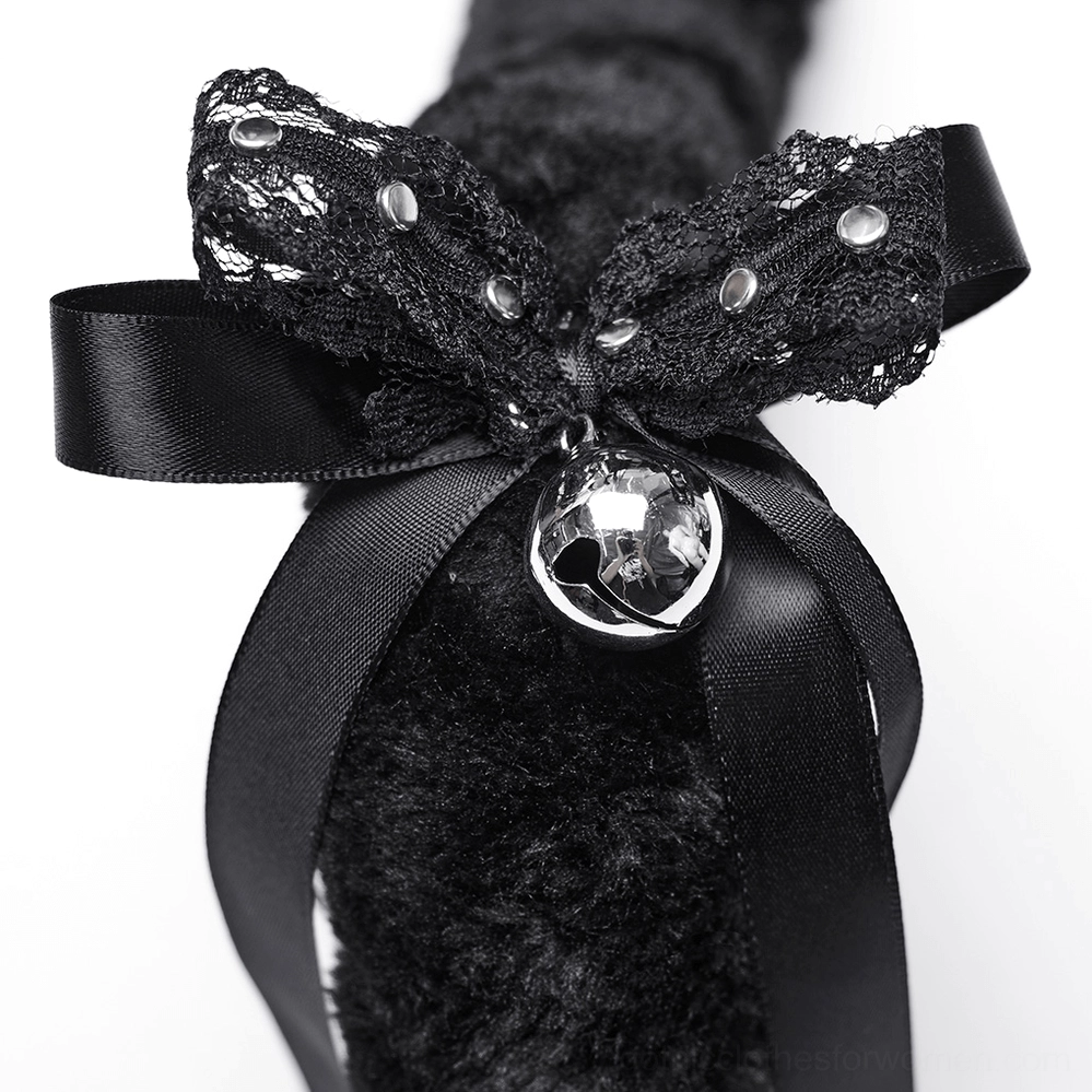 Close-up detail of black lace satin bow with metal rivets and dangling silver bell pendant on cat ear