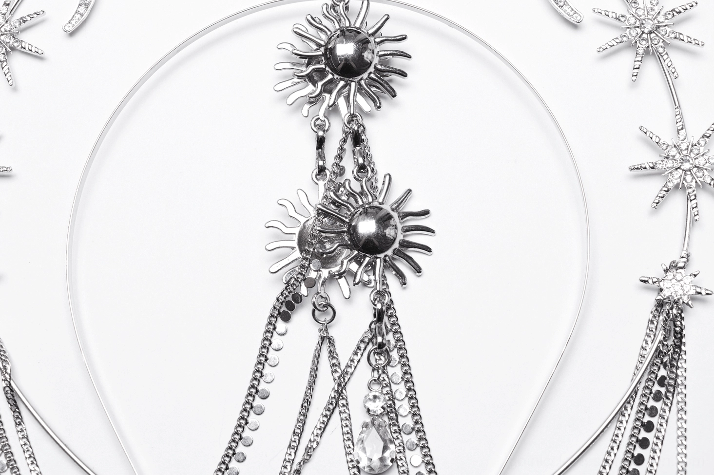 Close-up detail of celestial gothic crown components - sun-shaped charms multi-strand dangling chains with crystal pendants
