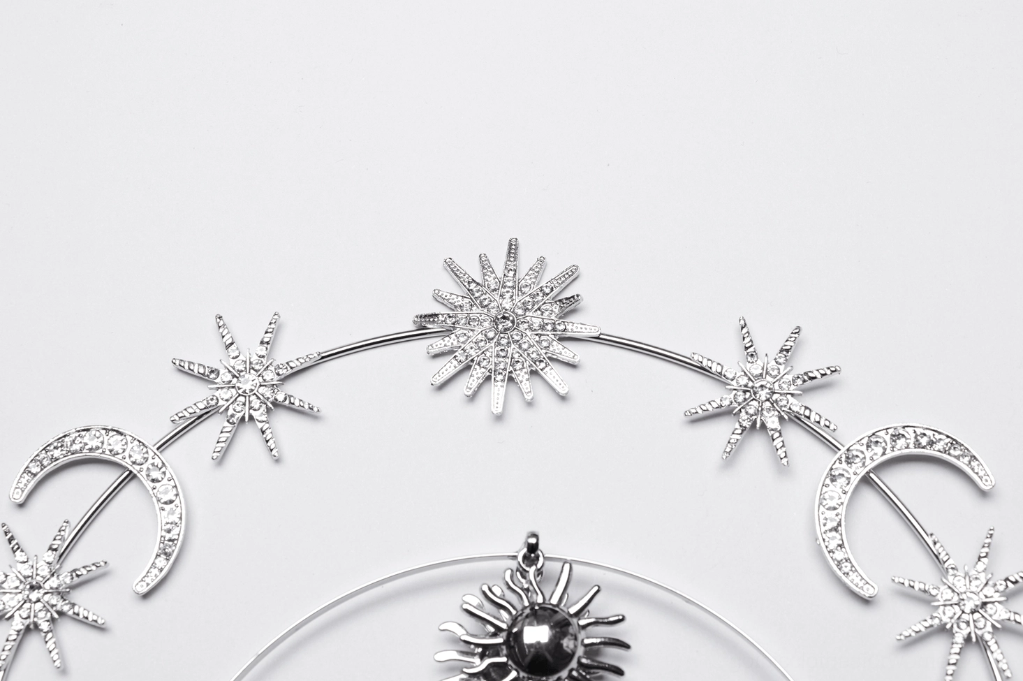 Celestial gothic crown frame close-up - star-shaped gemmed charms crescent moon accents and delicate silver chainwork