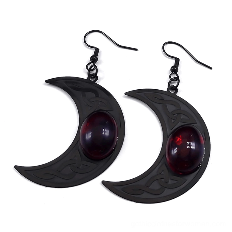 Celtic crescent moon earrings with red stone, stainless steel, engraved knot pattern, flat lay front view