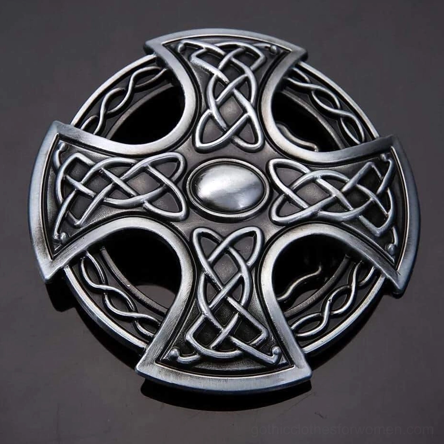 High-contrast top view of Celtic cross gothic buckle on dark reflective background highlighting antique silver finish and carved details