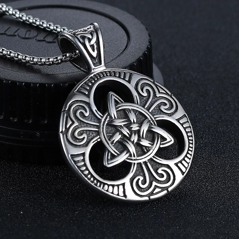 Antique silver Celtic knot pendant necklace three-quarter side angle, delicate carved decorative patterns and gothic mystical design