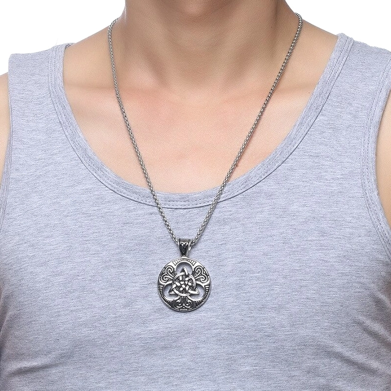 Male model wearing Celtic knot gothic pendant necklace, casual layered styling on neck and chest, alternative fashion wear