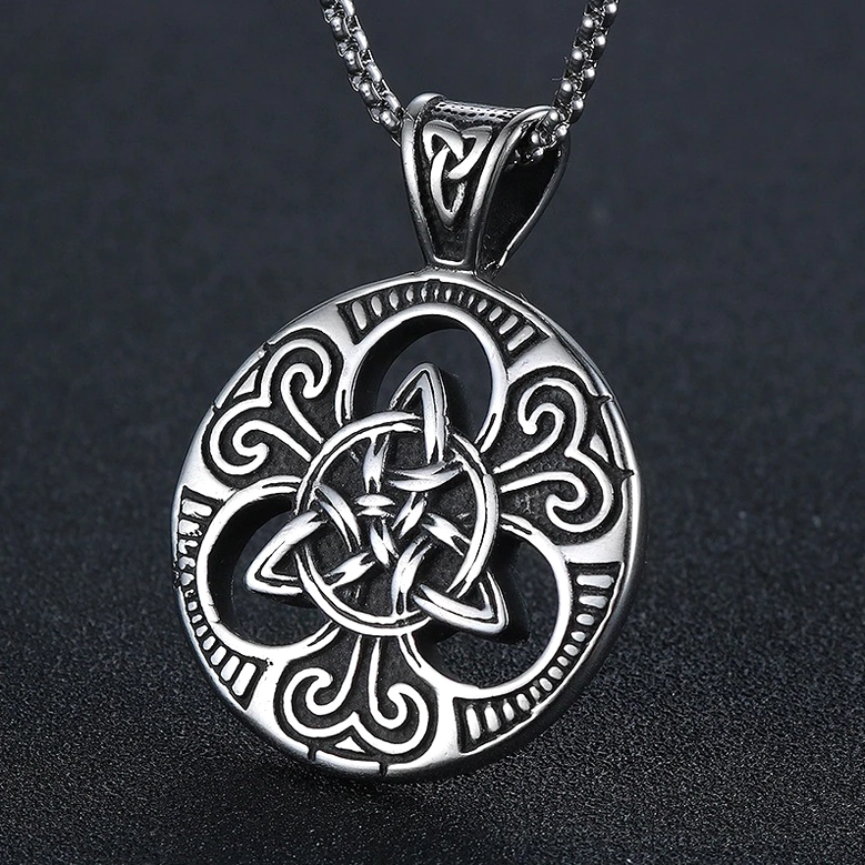 Celtic knot gothic pendant flat front view, stainless steel with central triquetra knot design on dark background