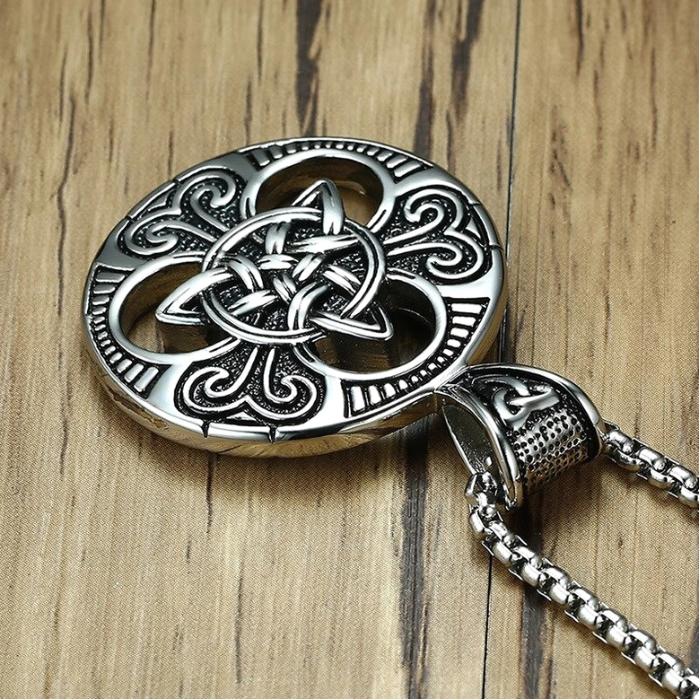 Celtic knot pendant side close-up showing stainless steel chain links and pendant side profile with worn vintage metal texture