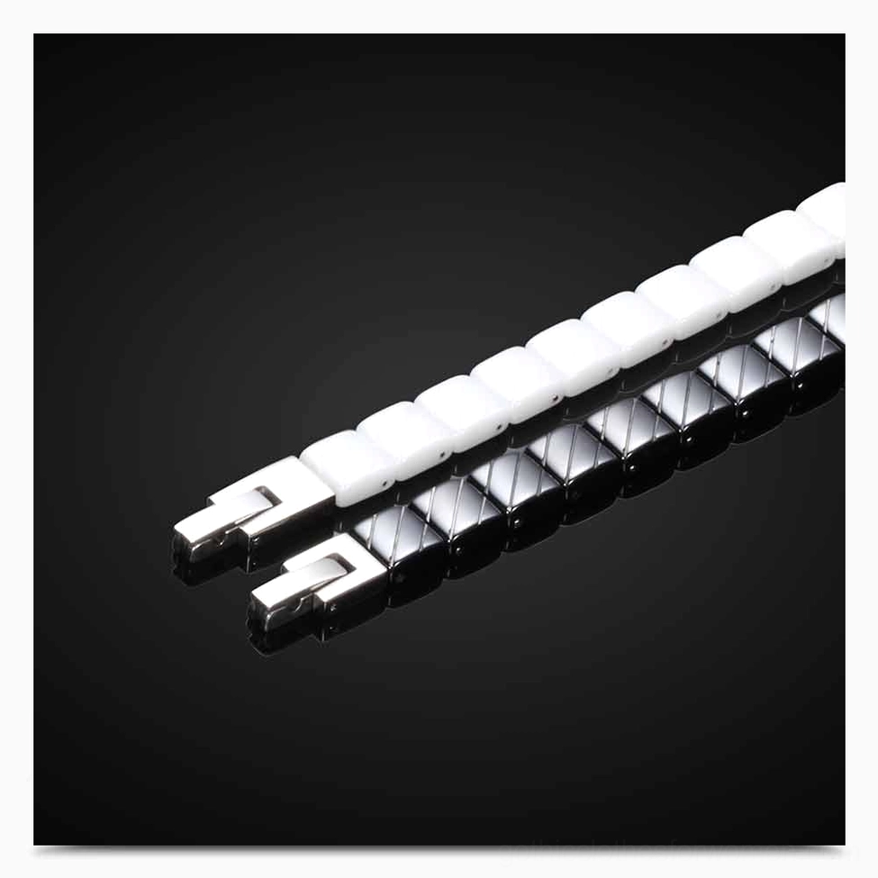 Close-up of ceramic bracelet link components and toggle clasp mechanism in black and white