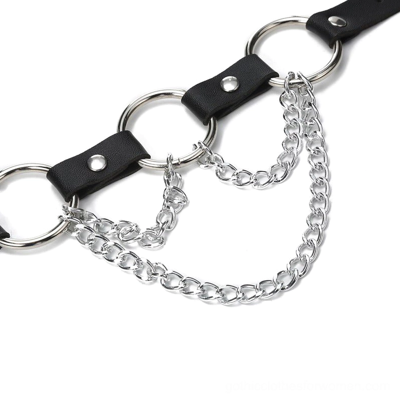 Close-up flat lay of waist belt chain details, showcasing silver metal chains, leather rivets, and precision metalwork