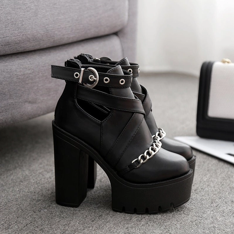 Black platform ankle boots styled with luxury accessories in home setting showing versatile gothic fashion styling