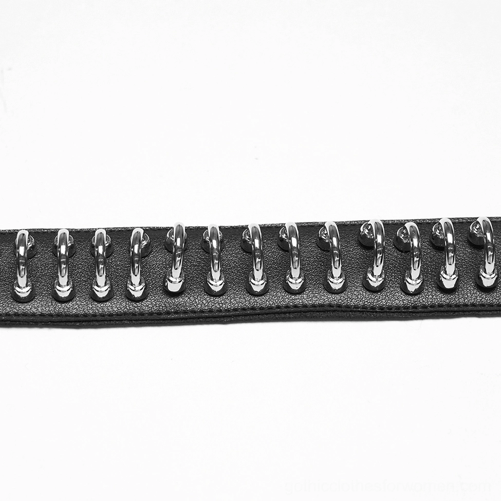 Side close-up of aligned silver metal rings on black leather showing texture and craftsmanship