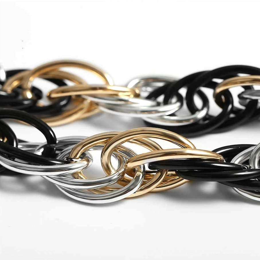 Detailed overhead view of thick twisted oval metal links in mixed tones, gothic chain texture and pattern