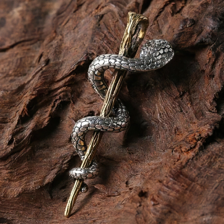 Silver and gold mixed metal cobra pendant showing serpent without gem on wood background