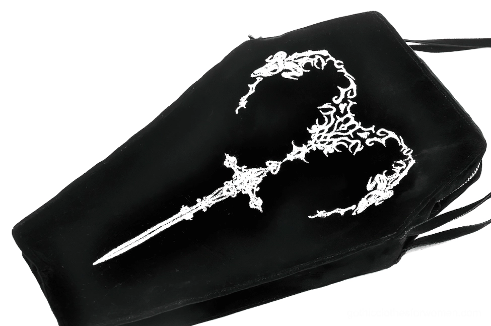 Close-up overhead view of coffin shoulder bag showing detailed embroidered sword and vine pattern fine craftsmanship