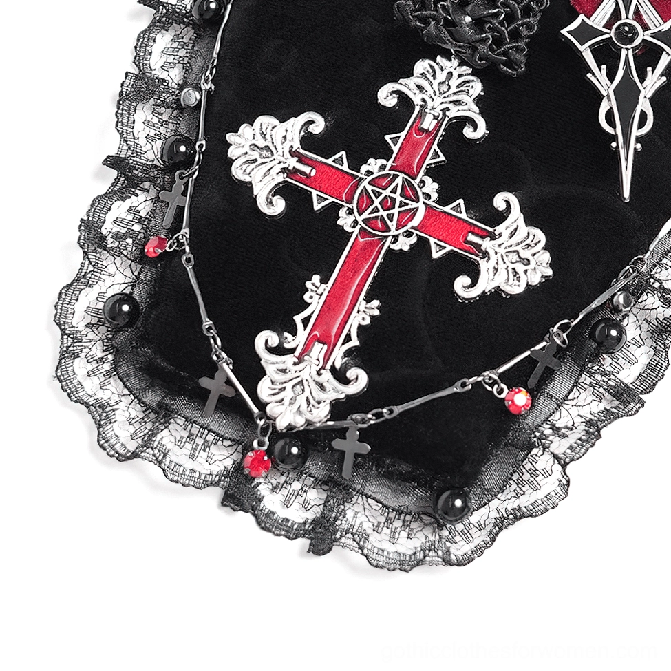 Side detail of gothic coffin brooch showing bead chain with red gem charms and tiny cross ornaments, highlighting dimensional embellishments