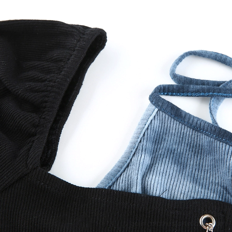 Collar and neckline detail of patchwork crop top showing ribbed knit fabric, color block stitching, and metal eyelet hardware