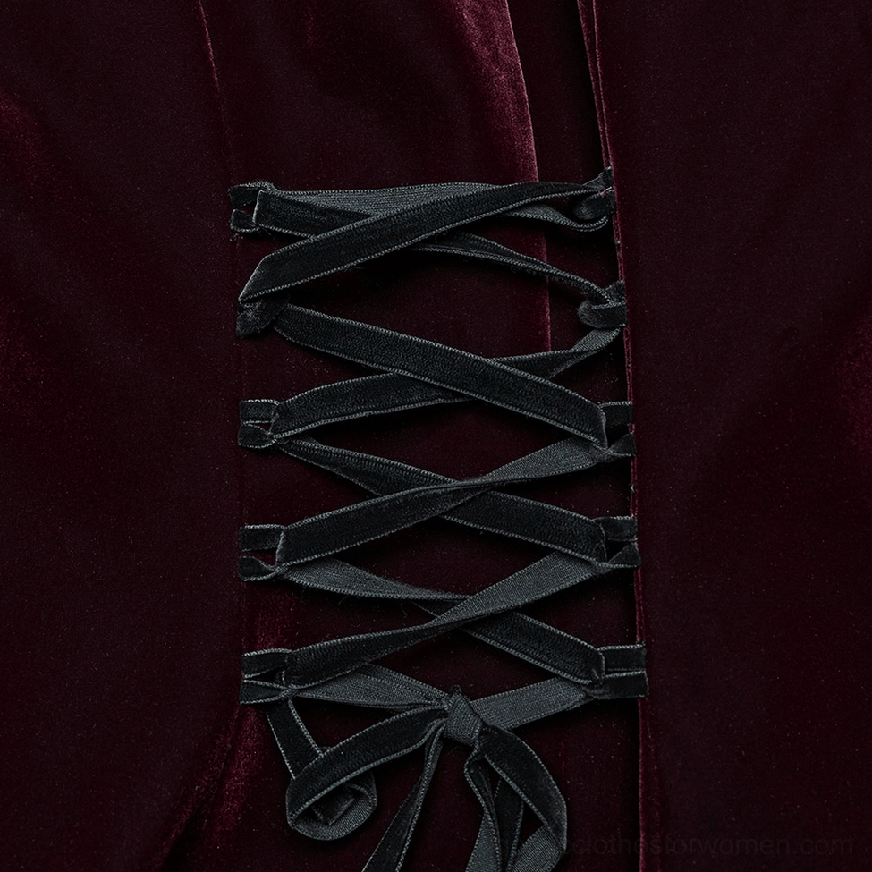 Extreme close-up of black velvet corset lacing and tied ribbon strap on gothic coat back