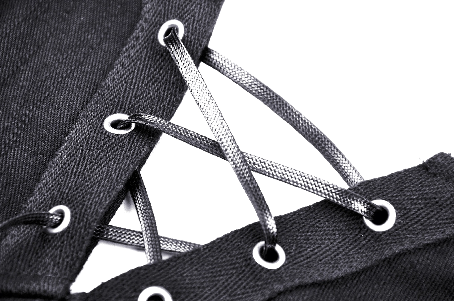 Close-up of corset front lace-up detail showing metallic cords and reinforced eyelet holes