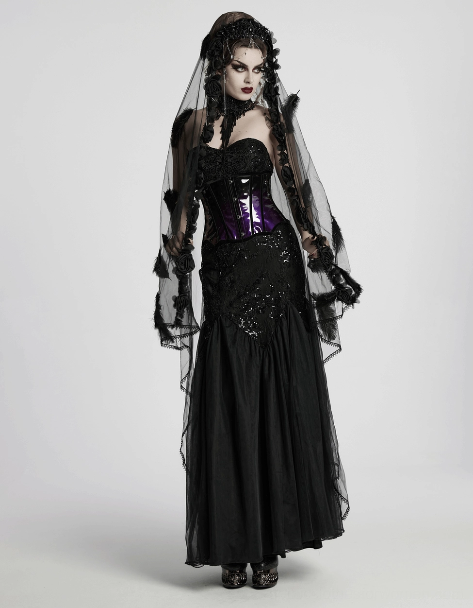 Underbust corset hem detail photography showing scalloped velvet-trimmed edge on glossy purple-black patent leather