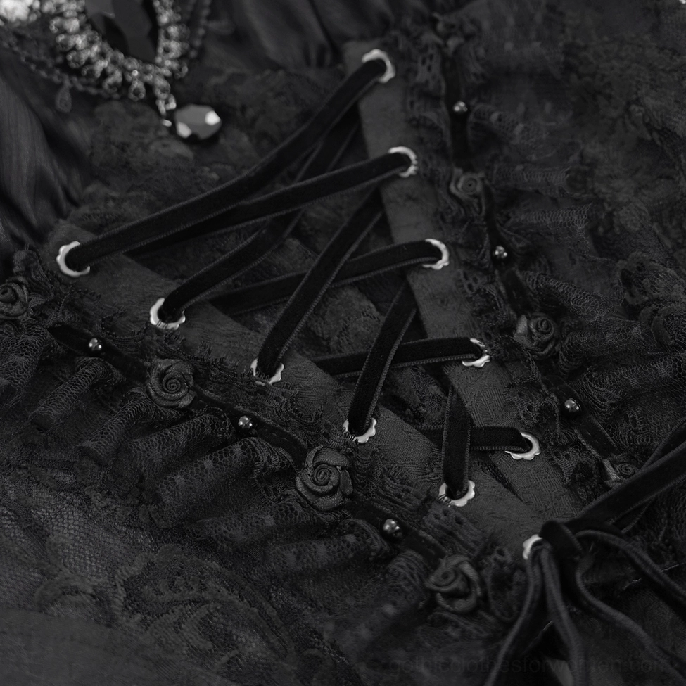 Close-up of velvet lace-up straps with rose-patterned embroidery and decorative bead accents