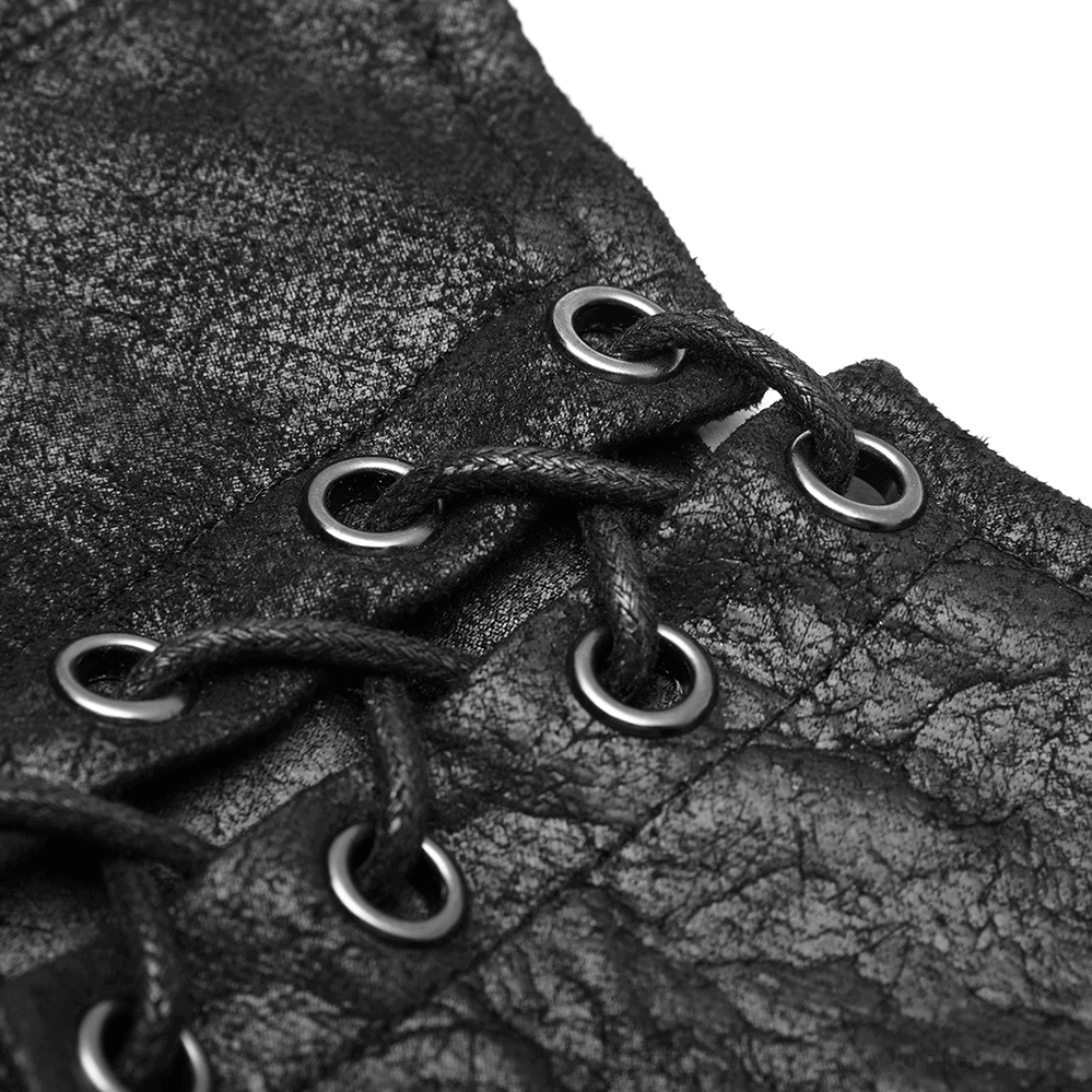 Close-up texture of cracked black PU leather with lace-up fasteners and metal eyelets