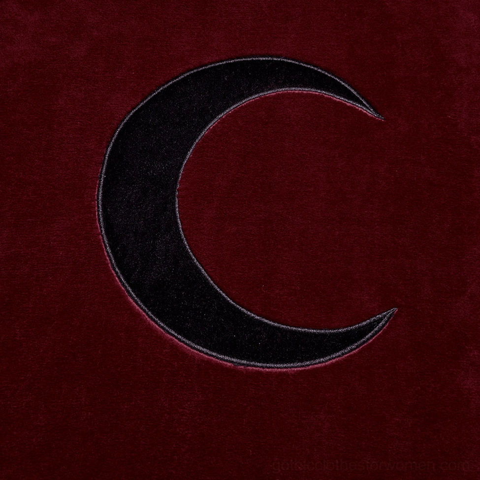 Black velvet crescent moon embroidery appliqué on wine red cape back, detailed close-up view